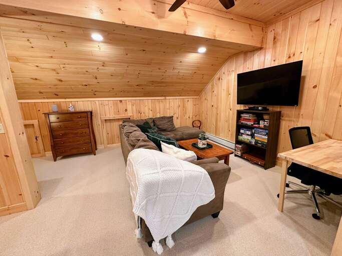 Loft with living area, TV, desk, games, and bunk beds