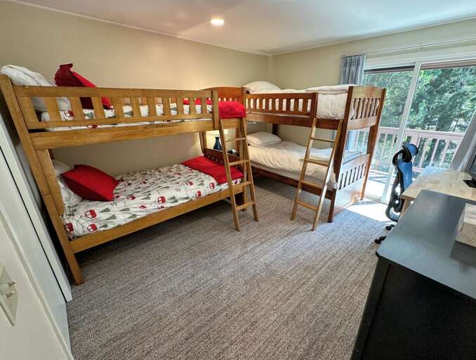 Upper level bunk room with 2 twin-over-twin bunks and a desk