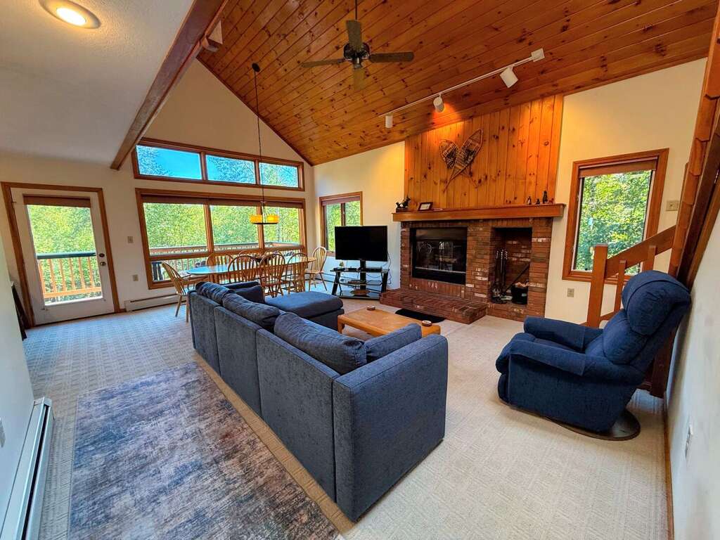 Main level living area with wood fireplace, TV with cable, and walkout to main level deck - adjacent to dining area and kitchen. Main level living area with wood fireplace, TV with cable, and walkout to main level deck - adjacent to dining area and kitchen.
