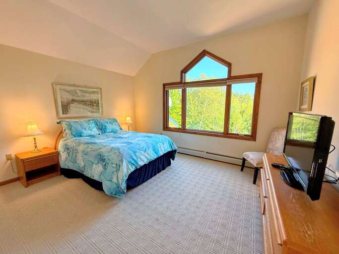 Upper level Queen Bedroom 1 with TV, ensuite bath and views Upper level Queen Bedroom 1 with TV, ensuite bath and views