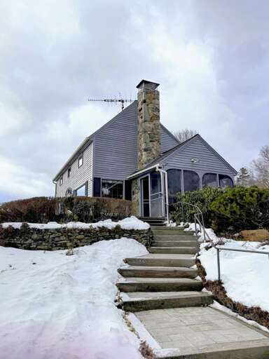 Snowy Steps To A Spacious Vacation Rental With Sizable Stone Chimney