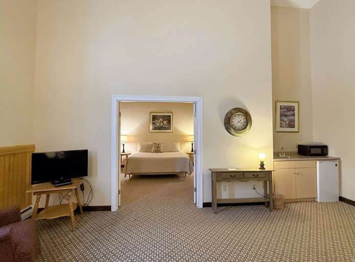 Room 3 sitting area with TV and kitchenette