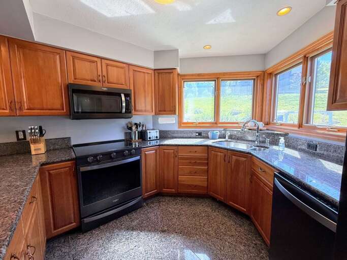 Kitchen boasts granite countertops and stainless steel appliances. The sink also has an instant hot water spigot!