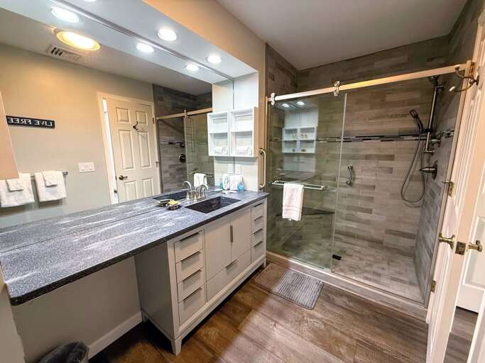 Attached bathroom has a full shower with beautiful tiled walls and a walk-in shower. Attached bathroom has a full shower with beautiful tiled walls and a walk-in shower.