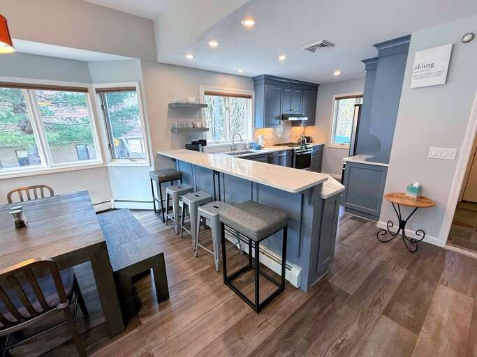 A modern and spacious kitchen with a cozy breakfast bar A modern and spacious kitchen with a cozy breakfast bar