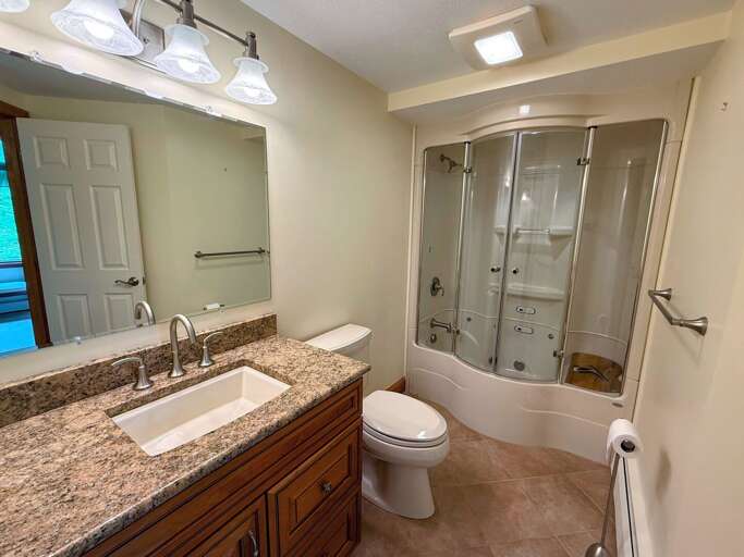 Upper level ensuite bathroom with steam shower