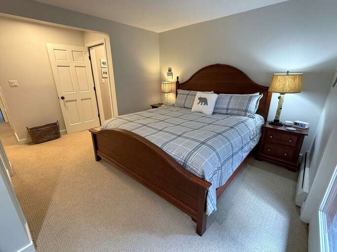Stretch out in the king bedroom, with matching bedside tables, lamps, and a private ensuite bathroom.
