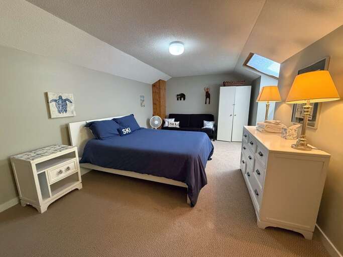 Another view of the queen loft, showing the skylight, storage, and workspace.