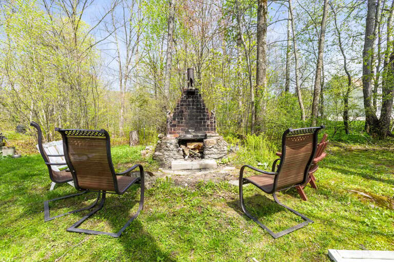 Step outside to your private backyard oasis, complete with a stone fire pit