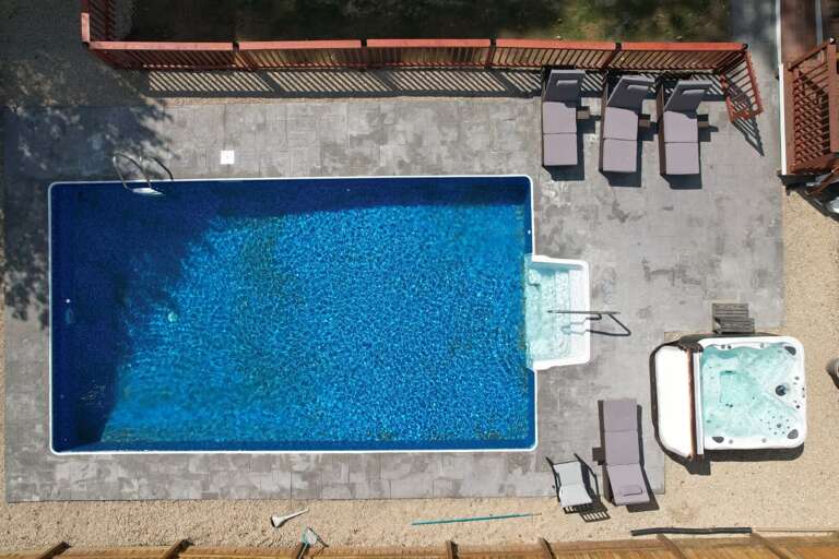 With a heated seasonal outdoor pool, fully fenced yard and year-round hot tub, this home is a vacation dream come true