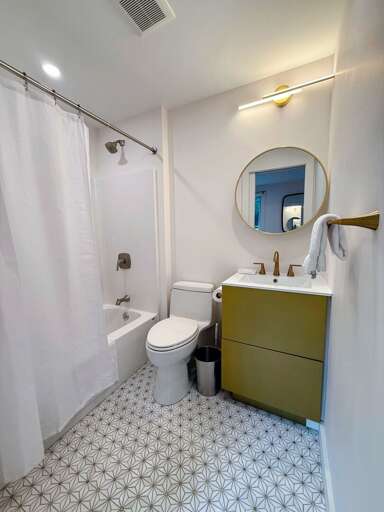 Main Floor Queen Bedroom ensuite full bath with shower/tub combo