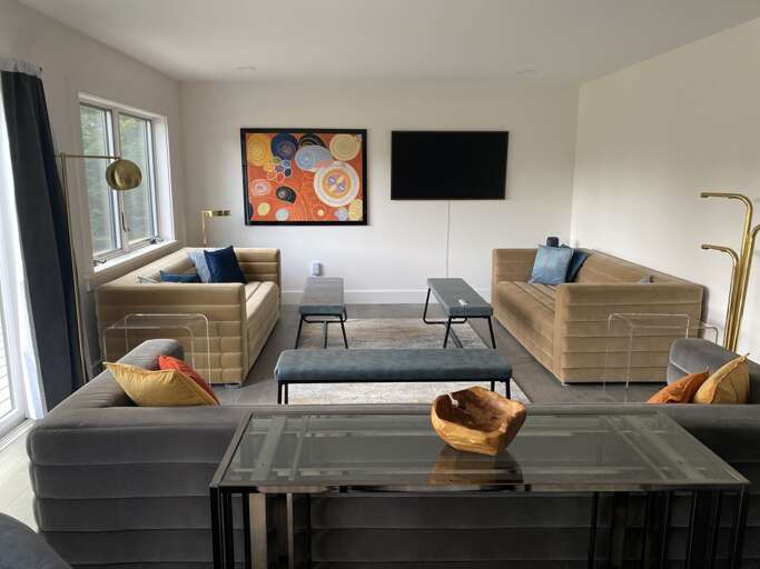 Open-concept living space designed for gathering and relaxation, with many seating areas to take advantage of the serene views or watch TV.