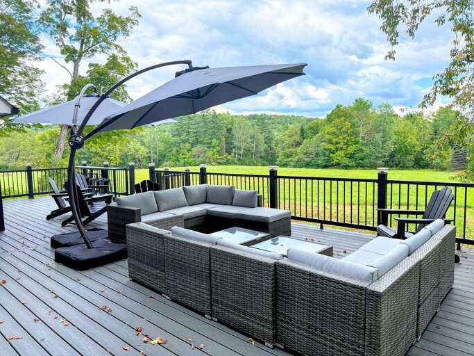 The sectional sofa, Adirondack chairs, and bar-style seating is the perfect spot to see the sunset or watch the kids play on the sprawling backyard lawn. The sectional sofa, Adirondack chairs, and bar-style seating is the perfect spot to see the sunset or watch the kids play on the sprawling backyard lawn.