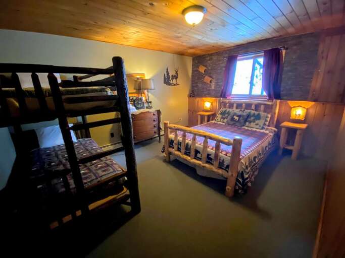 The other downstairs bedroom includes a queen bed and a twin/twin bunk bed for flexibility. Like other bedrooms, it's very cozy!