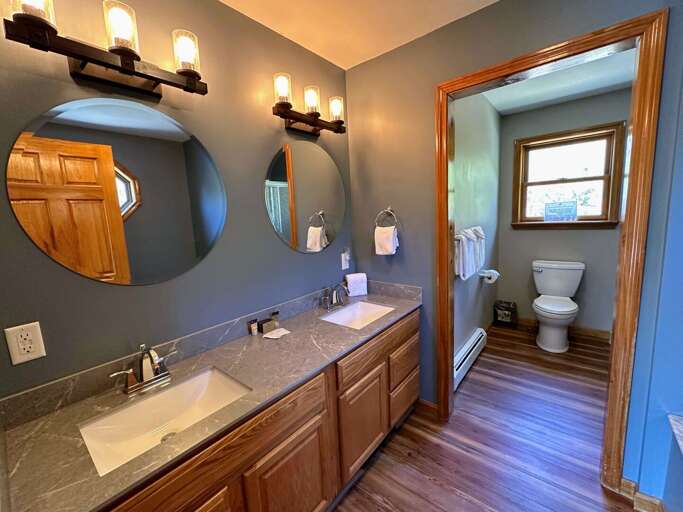 The primary bedroom's bathroom includes dual sinks, a jetted tub, and a separate shower/toilet area