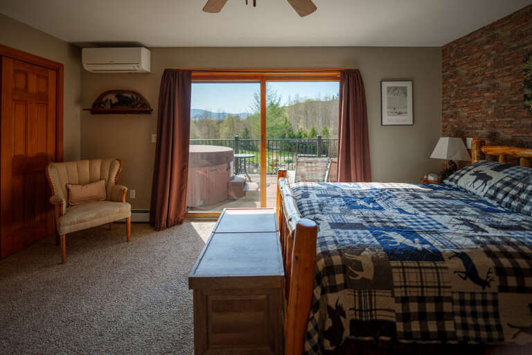 The primary bedroom suites features glorious views of the Presidential Range, and easy access to the outdoor hot tub (plus an indoor jetted tub!)