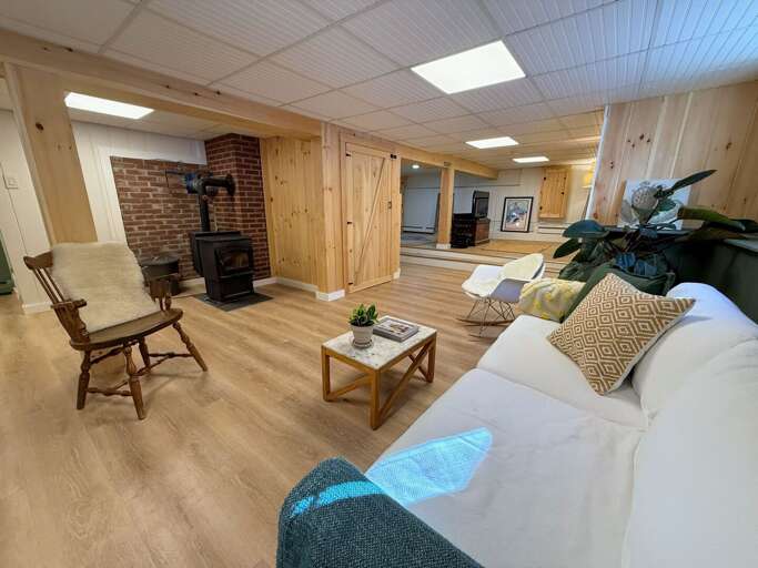 A second living space downstairs offers both a place to watch TV and cozy up the pellet stove