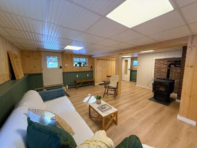 A second living space downstairs offers both a place to watch TV and cozy up the pellet stove