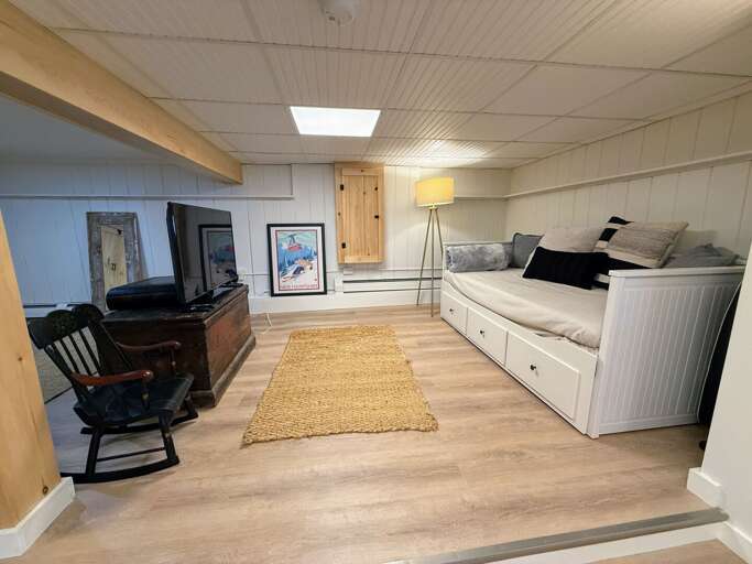 A second living space downstairs offers both a place to watch TV and cozy up the pellet stove. The day bed also provides additional sleeping space