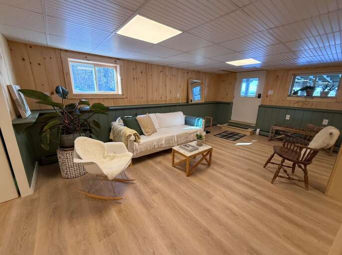 A second living space downstairs offers both a place to watch TV and cozy up the pellet stove