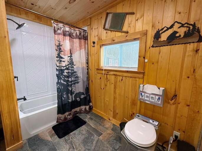 Bathroom with shower and incinerating toilet