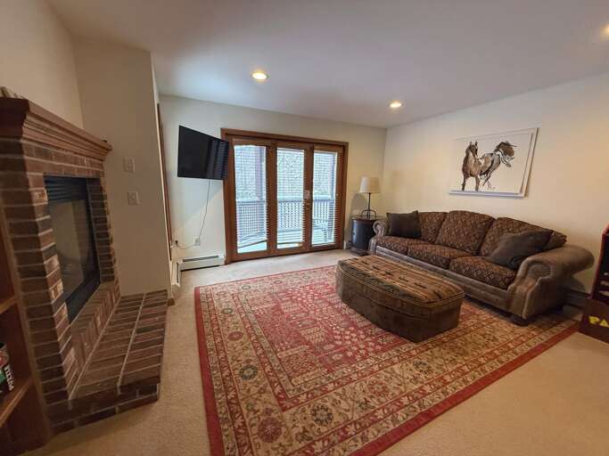 Lower Level Living Area with Gas Fireplace and TV.
