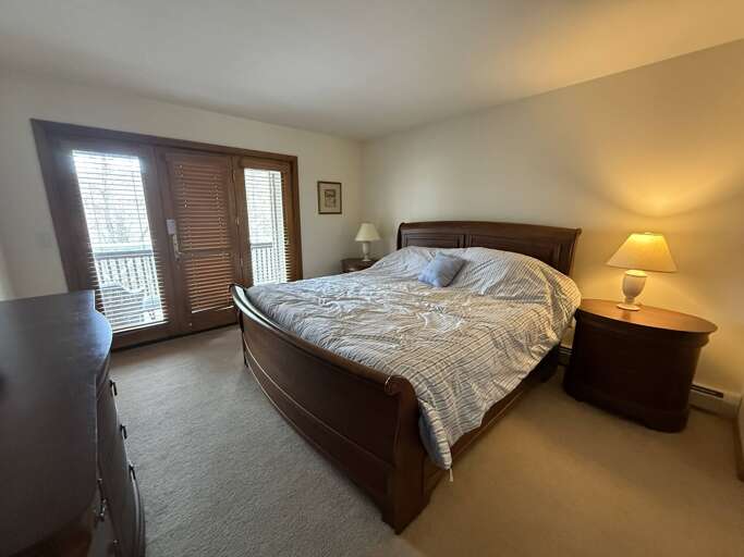 Main Level King bedroom with walkout access to shared deck and private ensuite bath