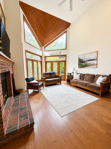 Open concept living, dining and kitchen area with Wood Burning Fireplace and TV