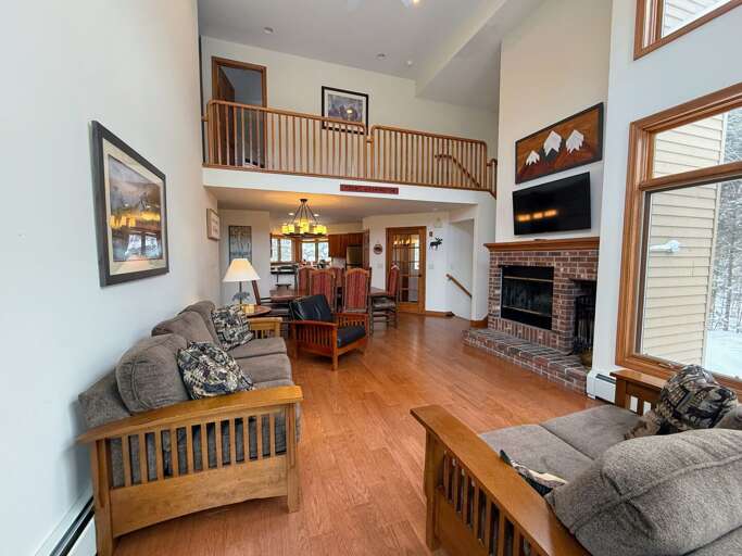 Open concept living, dining and kitchen area with Wood Burning Fireplace and TV