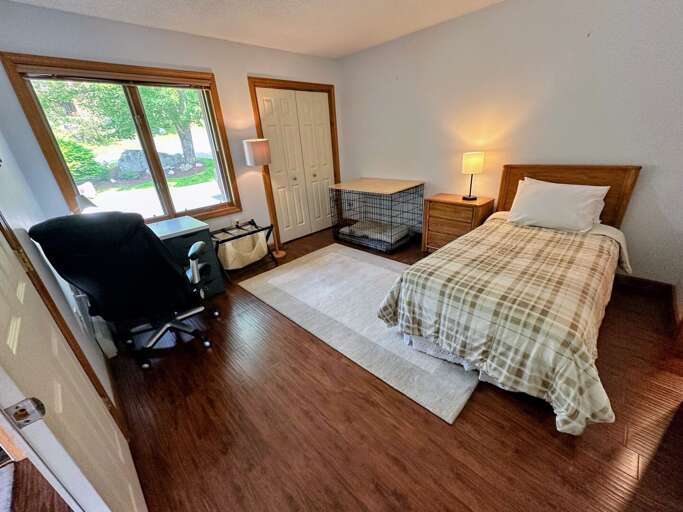 Main level bedroom with twin bed and desk