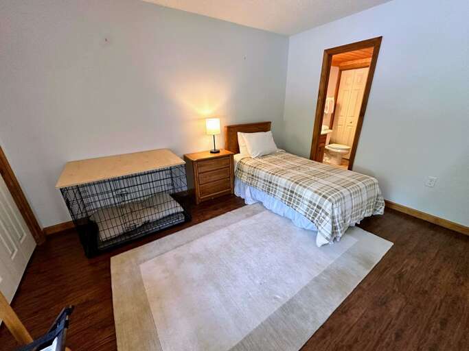 Main level bedroom with twin bed and desk