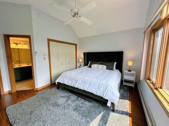 Upper level King bedroom with AC mini split, desk, TV and ensuite bath
