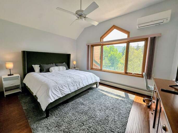 Upper level King bedroom with AC mini split, desk, TV and ensuite bath