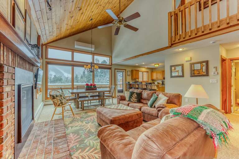 Main Level Living area with Gas Fireplace, TV and adjacent to Kitchen and Dining Areas