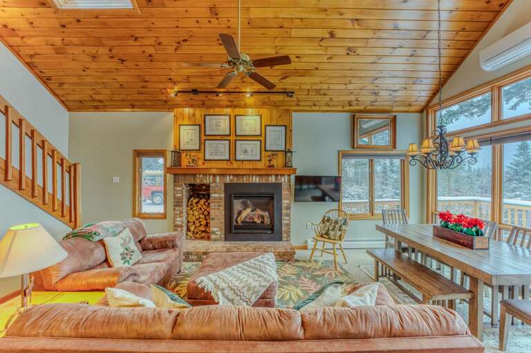 Main Level Living area with Gas Fireplace, TV and adjacent to Kitchen and Dining Areas
