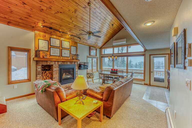 Main Level Living area with Gas Fireplace, TV and adjacent to Kitchen and Dining Areas