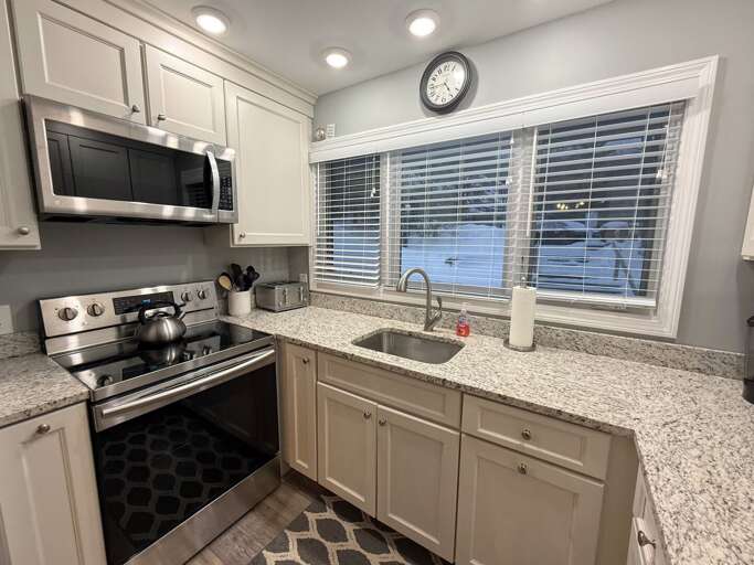 Updated Kitchen with stainless steel appliances and granite countertops.