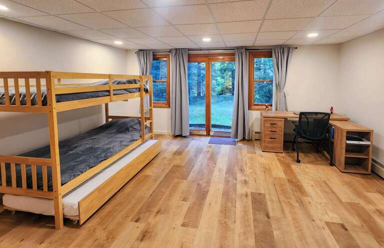 The lower level is equipped with a sitting area and Smart TV as well as a Twin-over-Twin Bunk Bed
