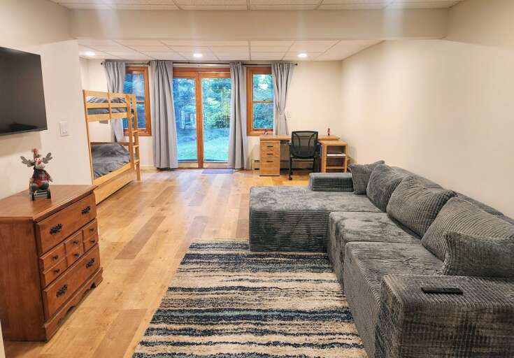 The lower level is equipped with a sitting area and Smart TV as well as a Twin-over-Twin Bunk Bed