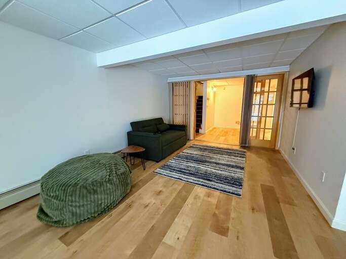 The lower level currently is equipped with a small sitting area and Smart TV as well as a Twin-over-Twin Bunk Bed. There is also a half bath on this level and walkout access to the back yard.