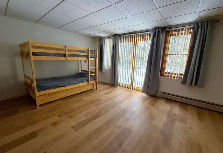 The Lower Level is equipped with a twin-over-twin bunk bed and walkout access to the yard.