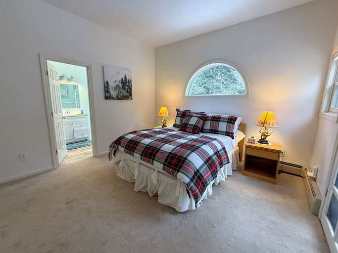 The Upper Level Queen Bedroom has a private walkout deck area and direct access to a Jack-and-Jill bathroom.