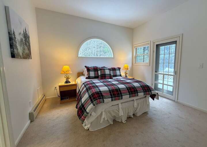 The Upper Level Queen Bedroom has a private walkout deck area and direct access to a Jack-and-Jill bathroom.