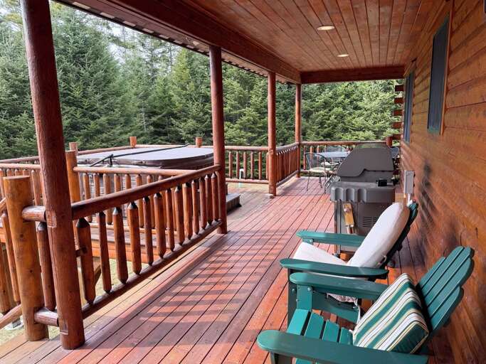 Deck with hot tub, table, grill and seating