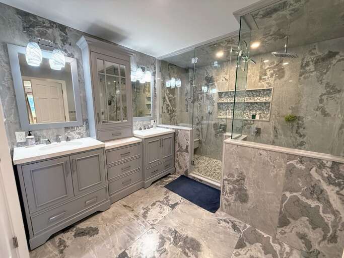 Main Level Primary King Bedroom Private Ensuite Bath with double vanity, dual-head walk-in shower, soaking tub, and water closet.