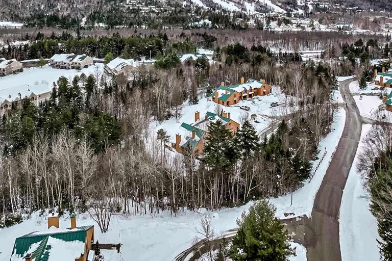 Winter aerial view of the home, nestled in the heart of Bretton Woods, with the ski area in the background