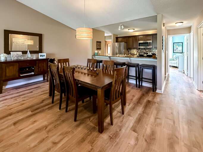 The dining table comfortably sits 6, and 5 additional seats are available at the bar counter