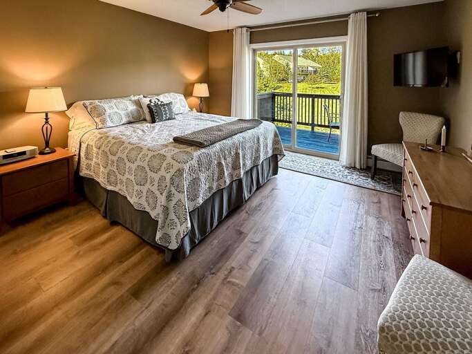 Primary bedroom with king bed, balcony access and ensuite bathroom