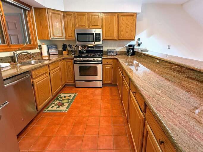 Main level kitchen offers granite countertops and stainless steel appliances.