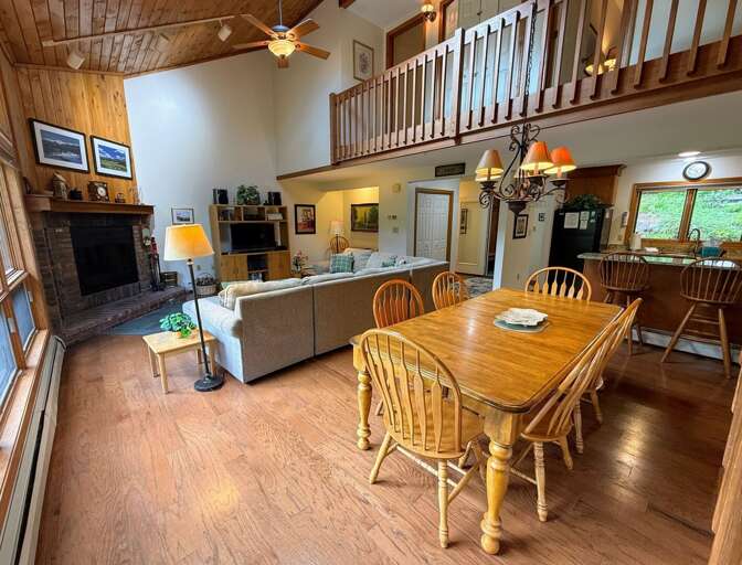 Main living area is an open concept space with living area, dining, breakfast bar, and kitchen right as you walk in.